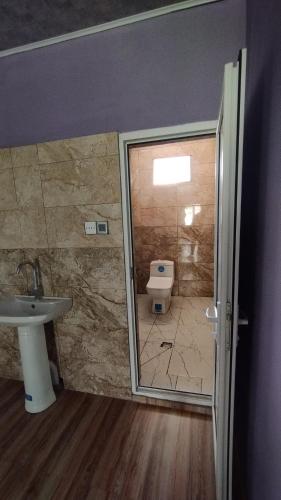 a bathroom with a toilet and a sink at Zaur Guest hause in Xınalıq