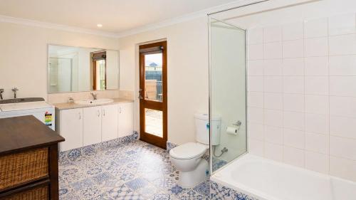 a bathroom with a toilet and a sink and a shower at Studio 66 Busselton in Busselton