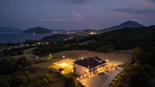 an aerial view of a building with lights at night at Hotel Agnanti Unique Hospitality in Kastoria