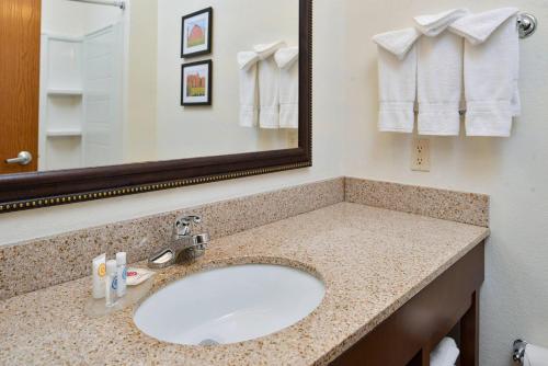 a bathroom with a sink and a mirror at Comfort Inn & Suites Madison North in De Forest