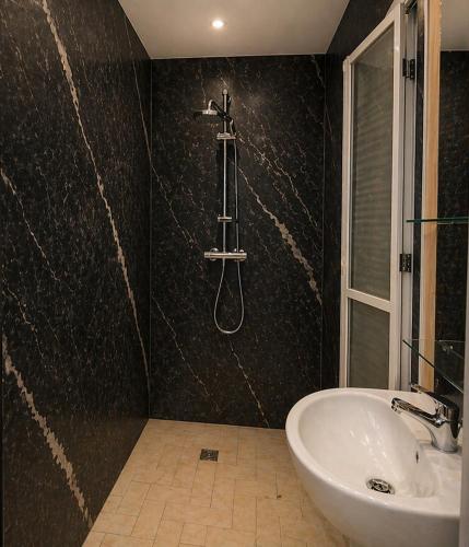 a bathroom with a sink and a bath tub at Hotel Albatros Wallis in Alele