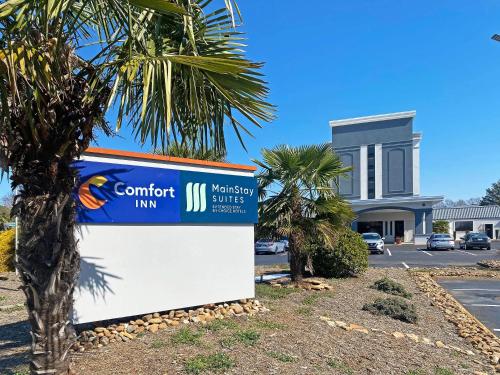 a sign in front of a building with a palm tree at Comfort Inn Conover-Hickory in Conover