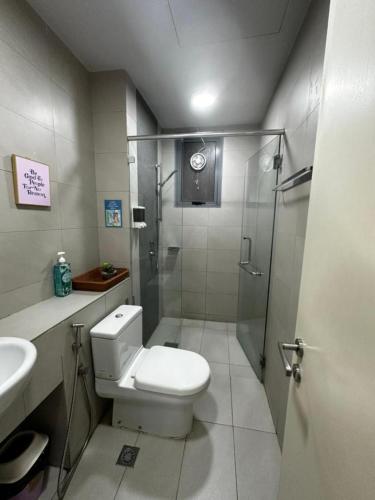 a bathroom with a shower and a toilet and a sink at VH HOMES l Imago Mall l 2BR Family Suite l Garden Direct Access in Kota Kinabalu