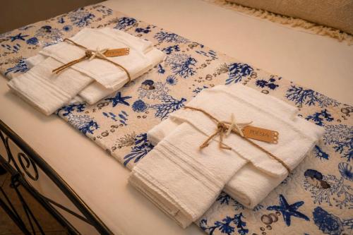 two towels sitting on top of a bed at Poésia in San Foca