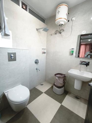 a bathroom with a toilet and a sink at Hotel Golden Olive in Kurukshetra