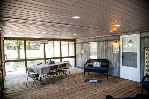 a room with a table and chairs on a wooden floor at Fisherman's Countryside Escape in Scottsboro