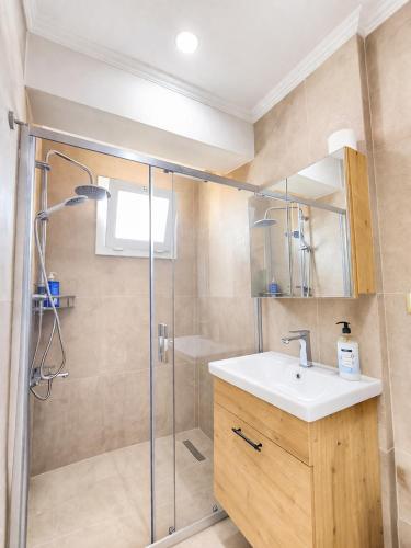 a bathroom with a sink and a shower at Villa Elma in Kuşadası