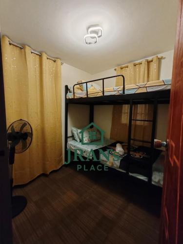 a room with two bunk beds in a room at JRAN's Place Home in Baliuag, Bulacan in Suliban