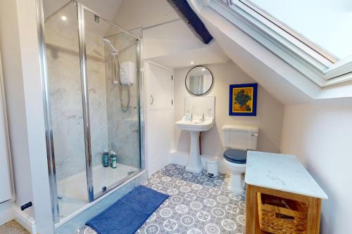 a bathroom with a shower and a sink and a toilet at The Winners Enclosure - Country Flat Above a Village Pub in Shrewsbury