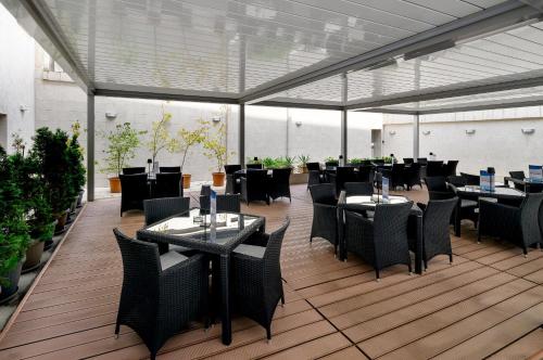 a restaurant with tables and chairs in a building at Continental Forum Sibiu in Sibiu