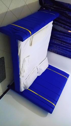 a bunk bed in a room with blue risers at Bamburi Mombasa two bedrooms at Cutraz homes villa 003 in Mombasa