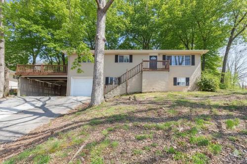 a large house with a porch and a tree at Quiet Getaway, Travis' Place! Affordable Location in Rossville