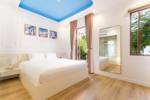 a bedroom with a white bed and a blue ceiling at HUB MULTI 3 HOTEL - Sea & Firework View in Phú Quốc