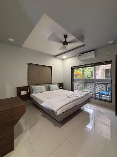 a bedroom with a bed and a ceiling fan at Encasa Resort in Nagaon