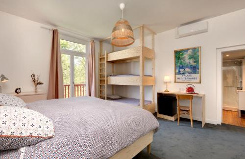 a bedroom with a bed and a book shelf at Chambres de charme avec piscine - Le Monde de Charlie - Proche Vichy in Vichy
