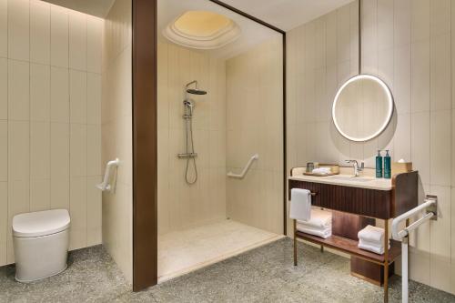 a bathroom with a shower and a sink and a toilet at Doubletree By Hilton Shenzhen Bay in Shenzhen