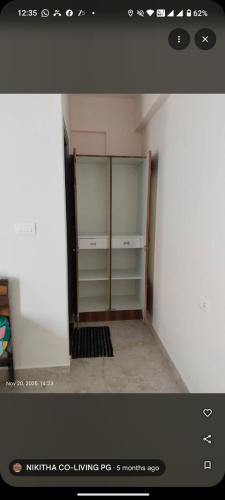 a room with a closet with glass shelves in it at nikitha co living pg in Bangalore