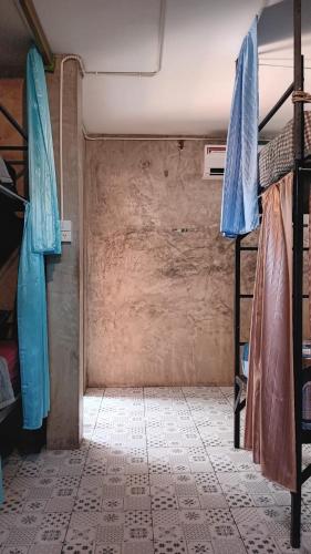 a room with two bunk beds and a tiled floor at Happy House Backpackers in Pai