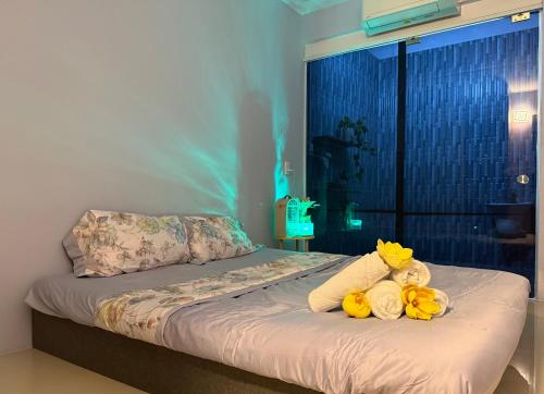 a bed with two stuffed animals on top of it at KEYDEO House in Phan Thiet