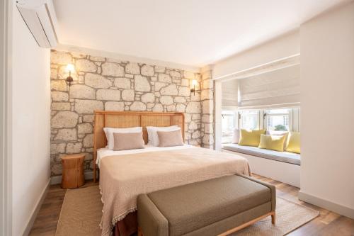 a bedroom with a large bed and a window at Fiora Alacati in Alaçatı