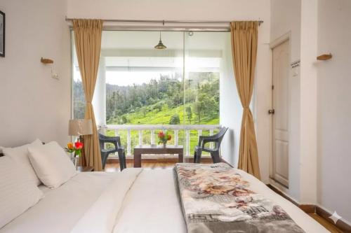 a bedroom with a bed and a large window at Winterbourne Chalet in Coonoor