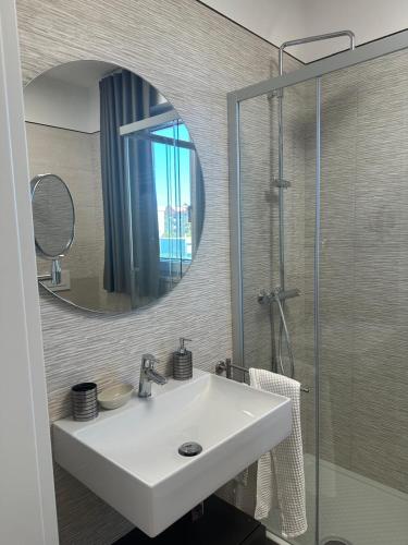 a bathroom with a white sink and a mirror at B&B Caricone in Orta Nova