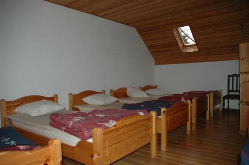 a bedroom with four beds in a room at Le Domaine Appartements in Bilstain