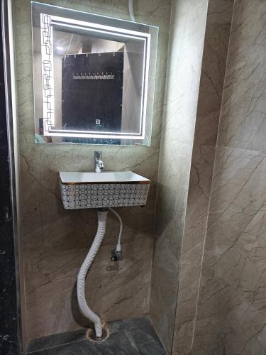 a bathroom with a sink and a mirror at Vasavi Homes in Mādhavaram