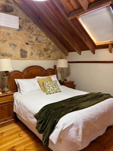 a bedroom with a large bed with a wooden headboard at Roscrow Heritage Retreat in Clare