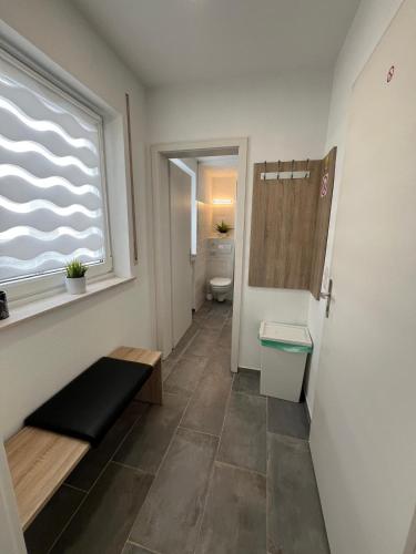 a bathroom with a toilet and a window at Gästezimmer Fateev 4 in Senden