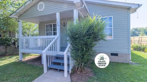 a blue house with a white staircase and a porch at Crossroads Cottage l Grill & high speed internet in Chattanooga