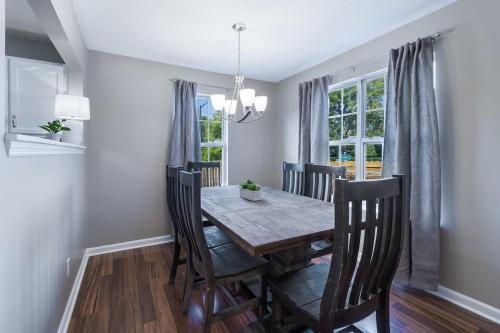 a dining room with a wooden table and chairs at Crossroads Cottage l Grill & high speed internet in Chattanooga