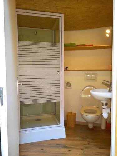 a bathroom with a toilet and a sink at Gite 4 etoiles en pleine nature 8 pers. in Entrepierres