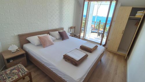 a bedroom with a bed with towels on it at Apartments Kust in Mlini