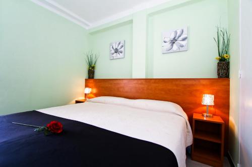 a bedroom with a bed with a red rose on it at Dms Planet Costa Dorada in La Pineda