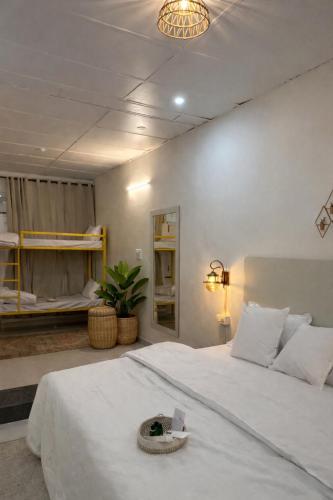 a bedroom with a large white bed with a basket on it at Bir Haus in Bīr