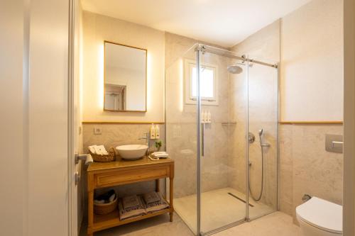 a bathroom with a shower and a sink and a toilet at Fiora Alacati in Alaçatı