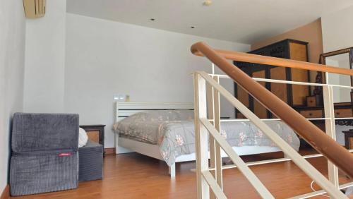 a bedroom with a bunk bed and a staircase at Mosaic condominium AD63M in Ban Tha Fat