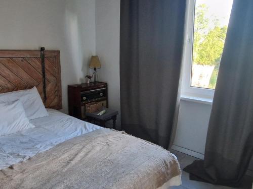 a bedroom with a bed and a window at Hillside view house with garden, private parking, quiet location - 12 min to Old town anytime, Long stays welcome in Vilnius