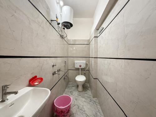 a small bathroom with a toilet and a sink at Vijay palace 850 meter away from Ram mandir in Ayodhya