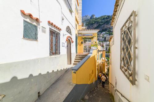 an alley in a city with people walking down it at Estate4home - Casa Bouganville in Positano