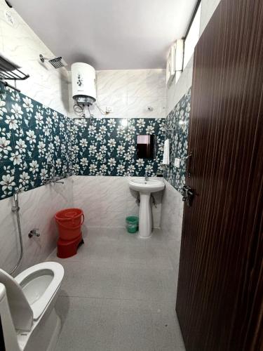 a bathroom with a toilet and a sink at Rautela Homestay in Lansdowne