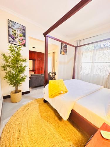 a bedroom with a large bed and a rug at Easyhomes bungalow apartment in Dar es Salaam