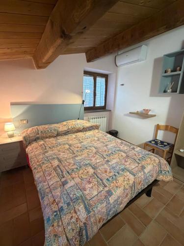 a bedroom with a large bed in a room at Affittacamere Castelmanardo in Amandola