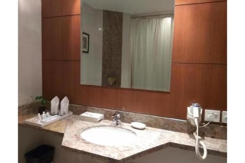 a bathroom with a sink and a large mirror at The Lagoona Resort in Lonavala