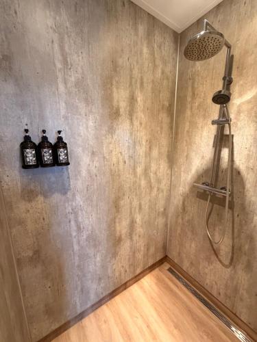 a bathroom with three bottles of water on a wall at B&B Diepzicht in Dokkum