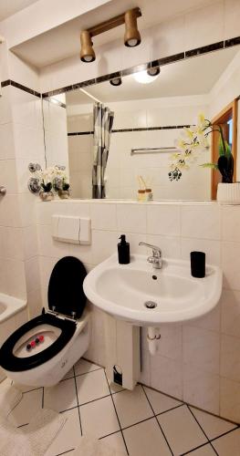 a white bathroom with a toilet and a sink at Cozy and beautiful flat in the centrum in Essen