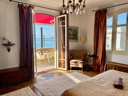 a bedroom with a bed and a view of the ocean at Villa Tricia Cannes in Cannes