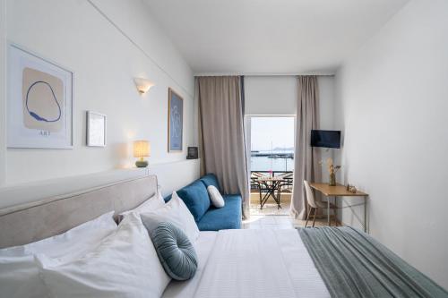 a bedroom with a bed and a living room at Flisvos in Sitia