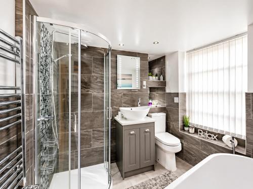 a bathroom with a toilet and a sink and a shower at Hexham Town Centre, Market Place View in Hexham